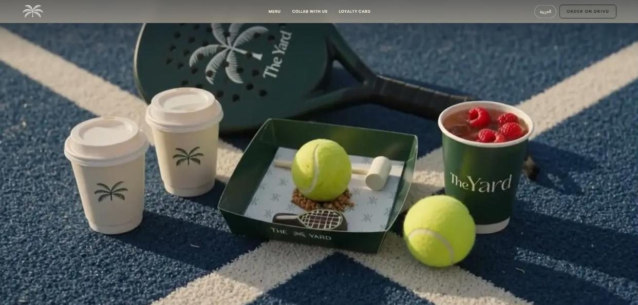 The Yard cafe site: branded cups, a tennis-ball dessert and a padel racket on a blue court